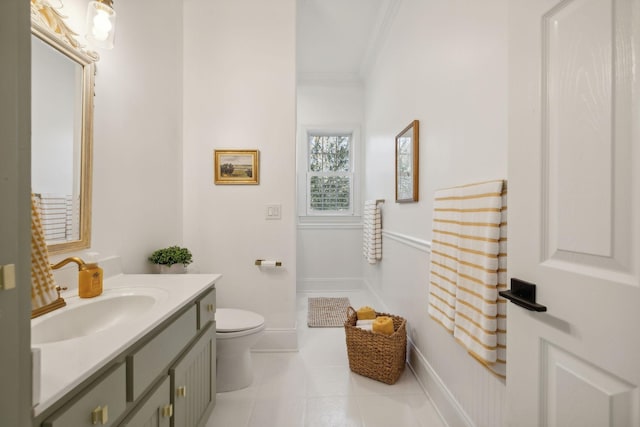 bathroom featuring vanity, tile patterned floors, ornamental molding, and toilet