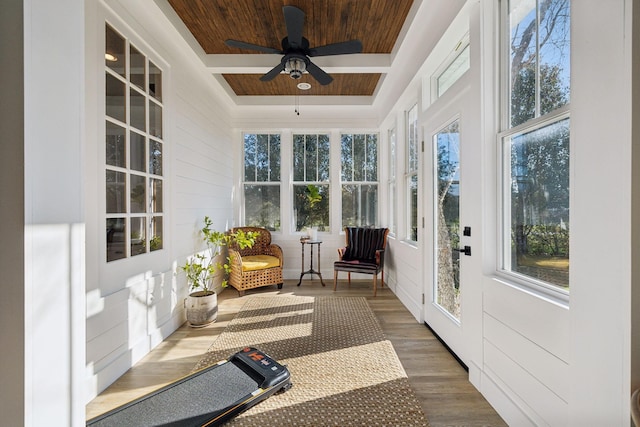 sunroom with ceiling fan, wood ceiling, and a tray ceiling