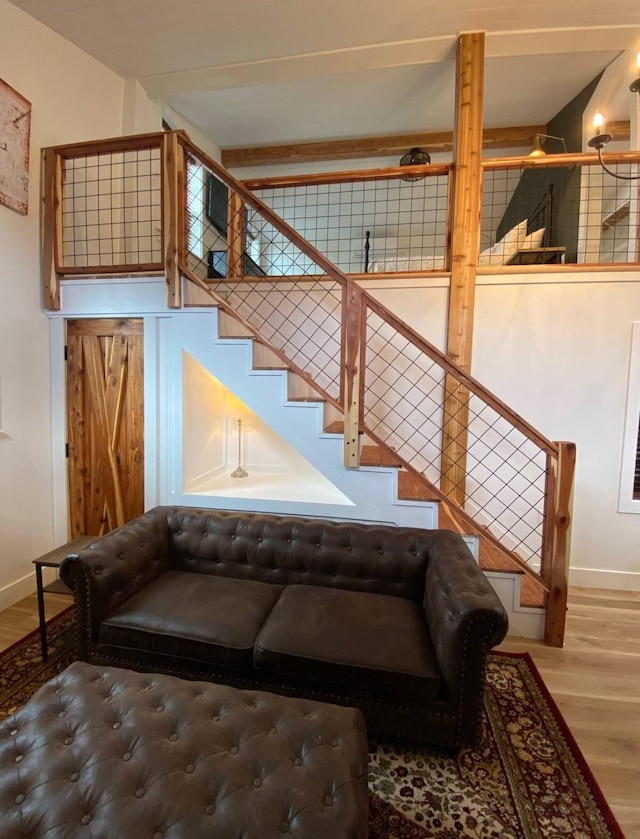 staircase featuring a towering ceiling and wood-type flooring