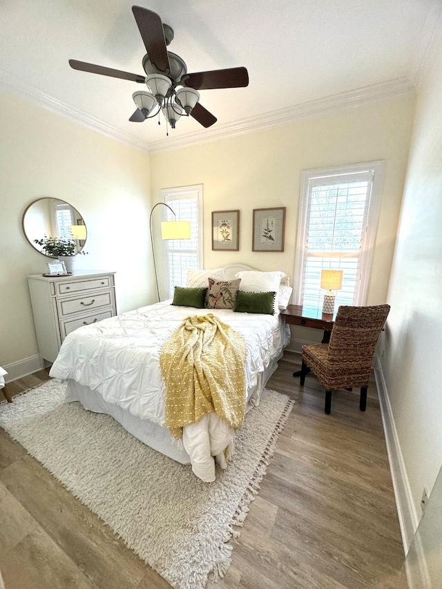 bedroom with ornamental molding, light hardwood / wood-style floors, and ceiling fan