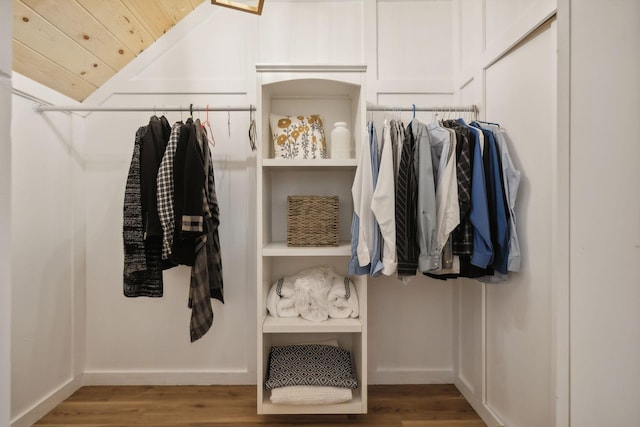 walk in closet featuring lofted ceiling and hardwood / wood-style flooring