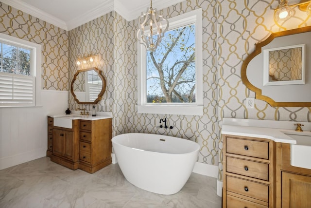 bathroom featuring an inviting chandelier, ornamental molding, a bath, and vanity