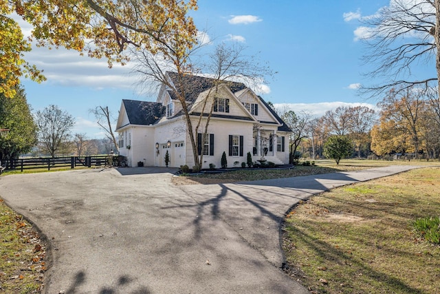 view of property exterior featuring a garage and a yard