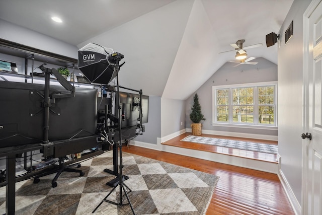 exercise room featuring lofted ceiling, hardwood / wood-style flooring, and ceiling fan