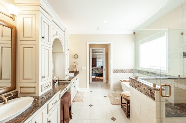 bathroom featuring plus walk in shower, tile patterned floors, vanity, and crown molding