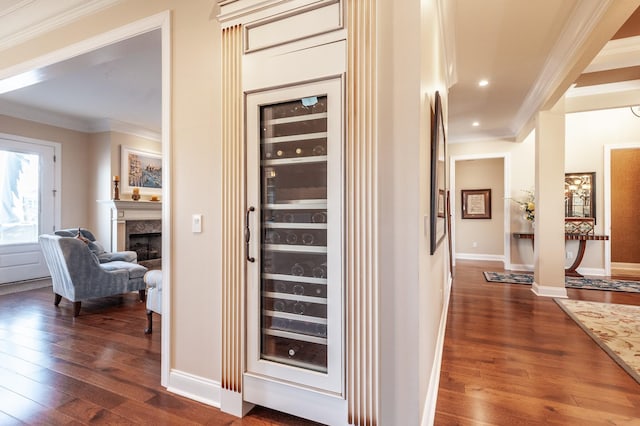 interior space with crown molding, dark hardwood / wood-style flooring, and wine cooler