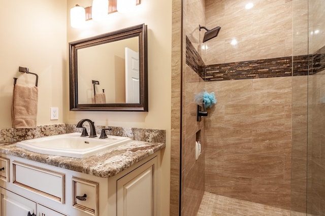 bathroom featuring vanity and a tile shower