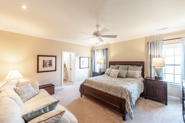 bedroom with ceiling fan, ornamental molding, connected bathroom, and light carpet