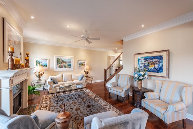 living room featuring a premium fireplace, crown molding, ceiling fan, and dark hardwood / wood-style flooring