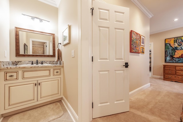 bathroom with ornamental molding and vanity