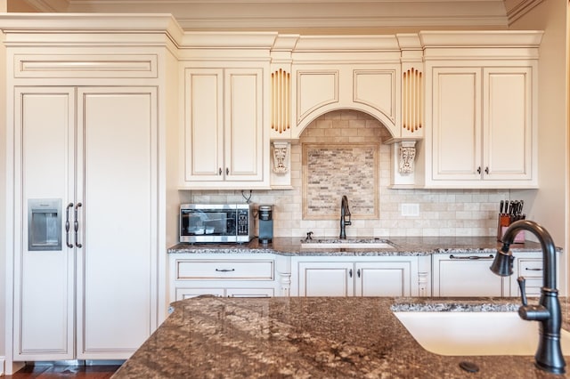 kitchen featuring dark stone counters and sink