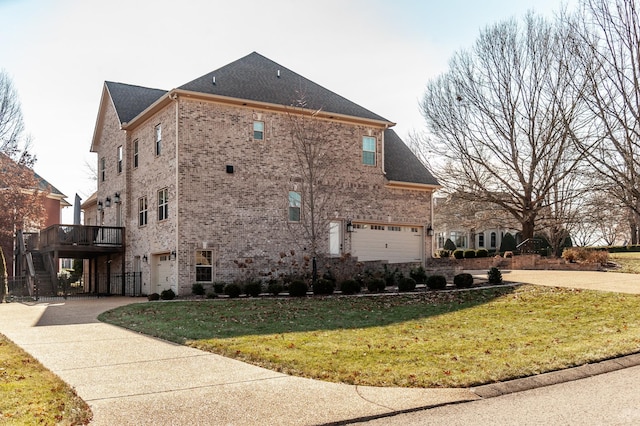 view of side of property featuring a garage and a yard