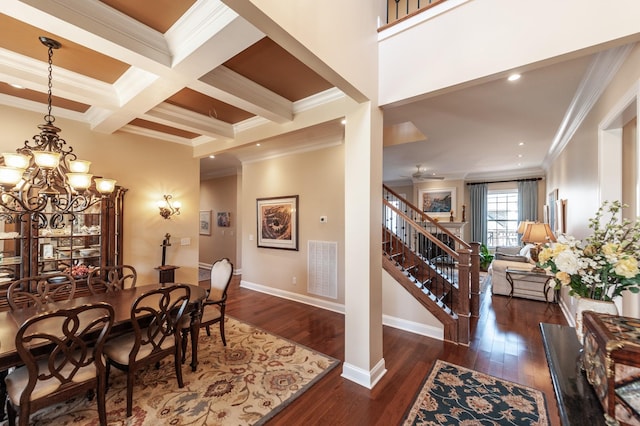 dining area with beamed ceiling, dark hardwood / wood-style floors, ornamental molding, and coffered ceiling