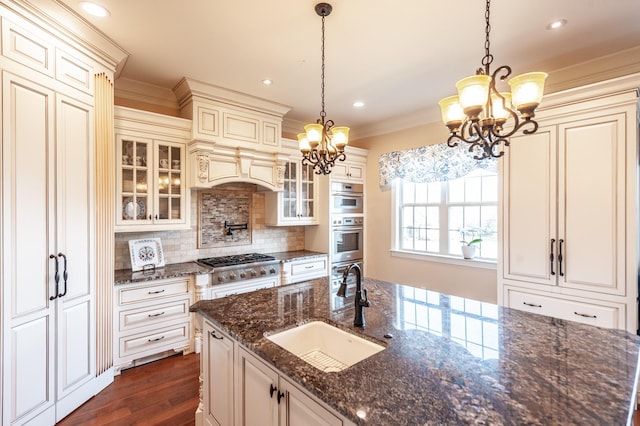 kitchen featuring pendant lighting, sink, and an inviting chandelier