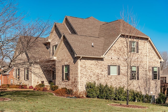 view of side of home featuring a lawn