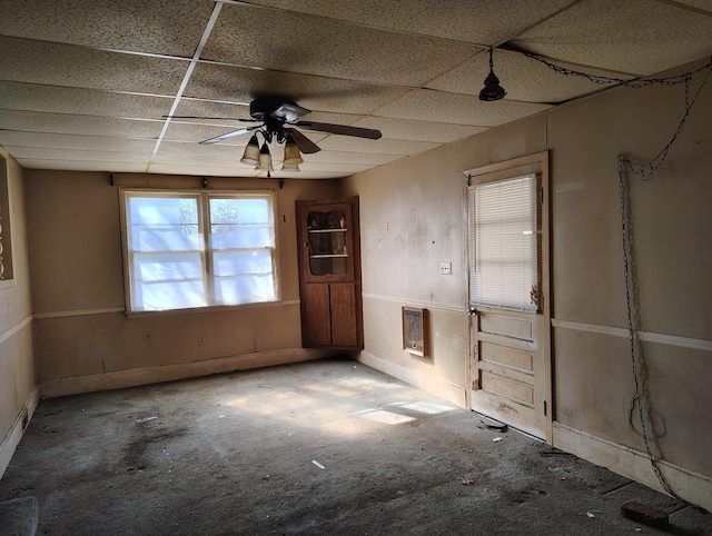 spare room featuring a paneled ceiling, heating unit, and ceiling fan