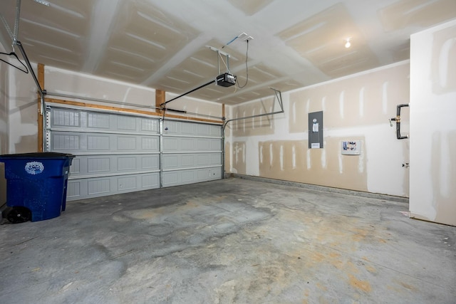 garage with a garage door opener and electric panel