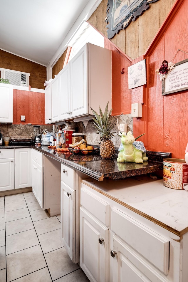 kitchen with white cabinetry, light tile patterned flooring, and decorative backsplash