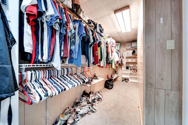 walk in closet featuring carpet flooring