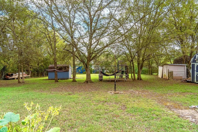 view of yard featuring a storage shed and a trampoline