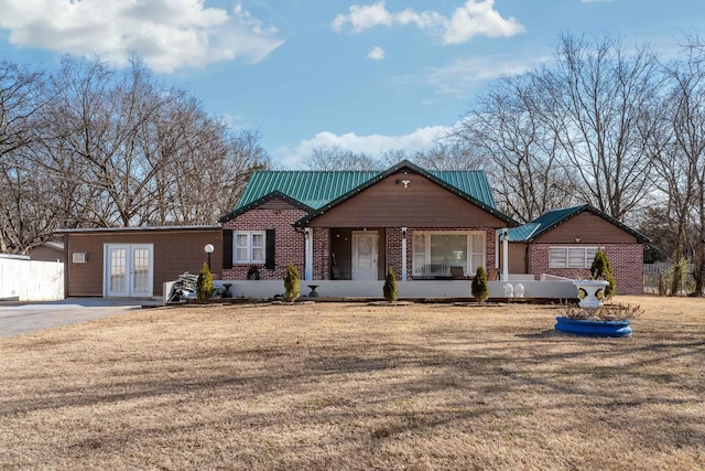 view of front of home featuring french doors and a front yard