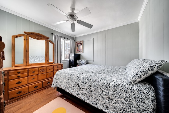 bedroom featuring crown molding, ceiling fan, and hardwood / wood-style flooring