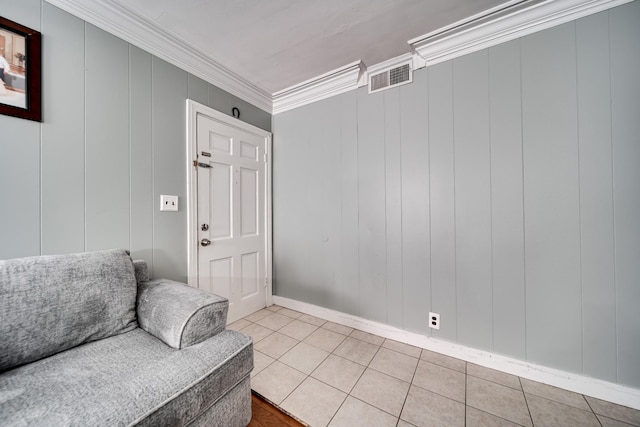 sitting room featuring crown molding and light tile patterned flooring