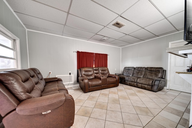 tiled living room featuring a paneled ceiling