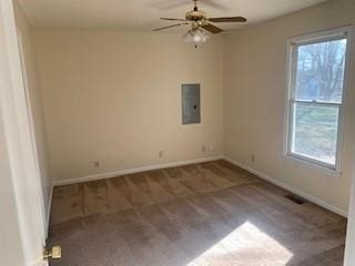 empty room with a wealth of natural light, electric panel, and ceiling fan