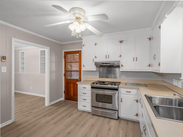 kitchen featuring white cabinetry, sink, light hardwood / wood-style floors, and stainless steel gas stove