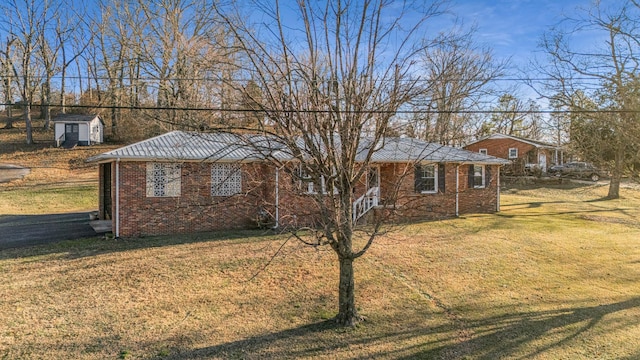 ranch-style home with a shed and a front lawn