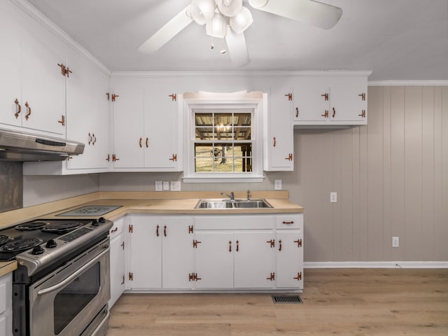 kitchen featuring crown molding, stainless steel electric range oven, sink, and white cabinets