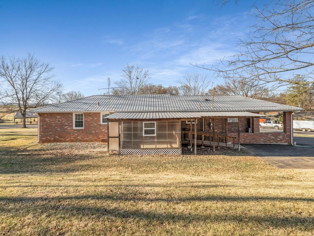 back of house featuring a yard and a carport