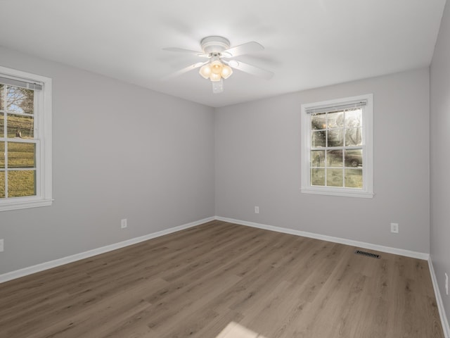 unfurnished room with wood-type flooring and ceiling fan