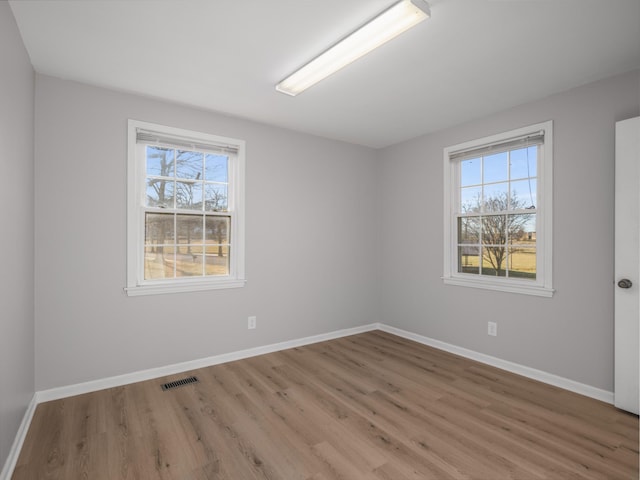 spare room featuring hardwood / wood-style floors