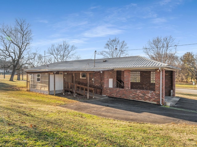 back of property featuring a lawn