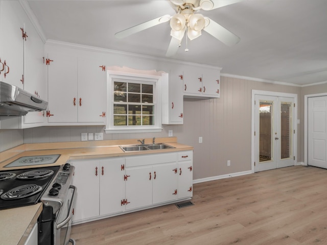 kitchen featuring sink, crown molding, light wood-type flooring, stainless steel electric stove, and white cabinets