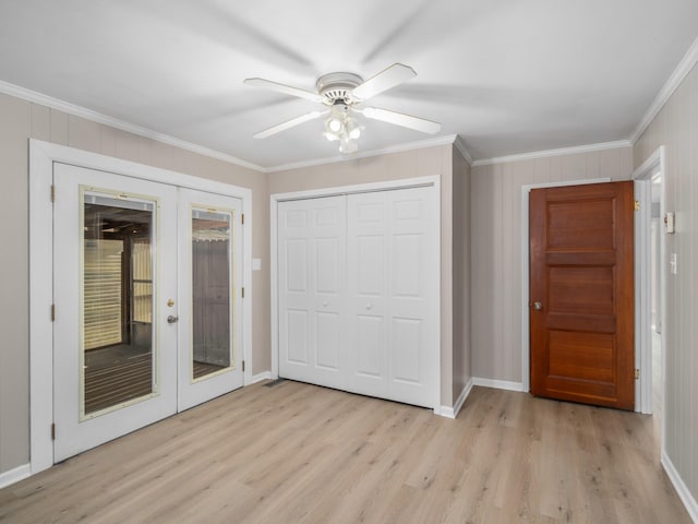 unfurnished bedroom featuring ornamental molding, ceiling fan, light hardwood / wood-style floors, and french doors