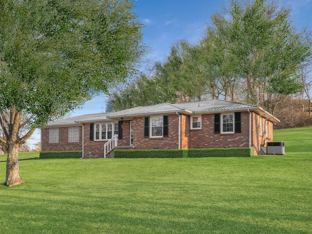 single story home featuring central air condition unit and a front lawn