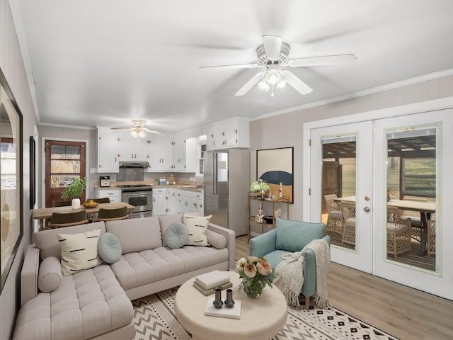 living room with sink, crown molding, ceiling fan, french doors, and light wood-type flooring