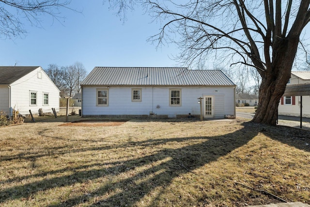 back of property with a lawn