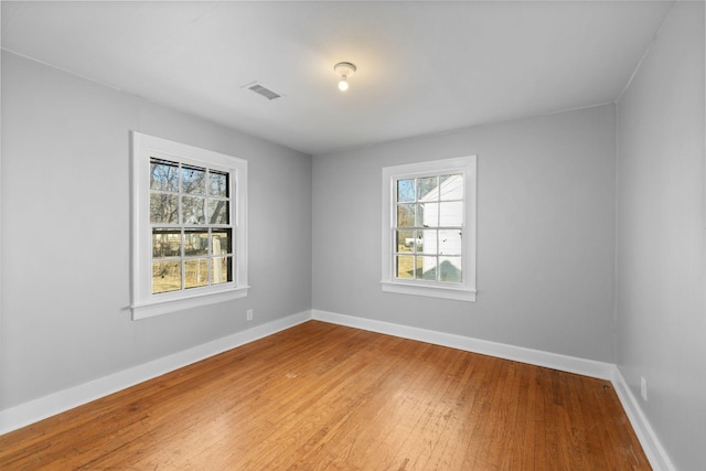 unfurnished room with wood-type flooring