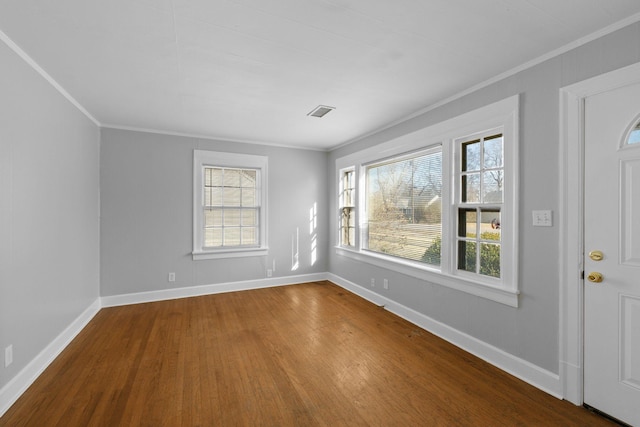 foyer entrance featuring hardwood / wood-style floors and crown molding