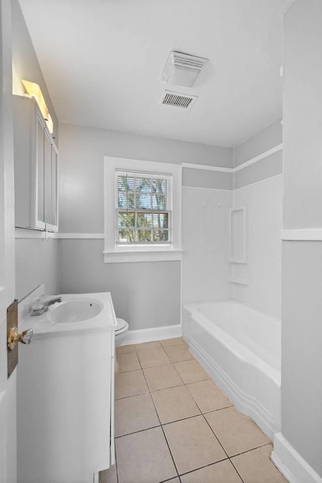 full bathroom featuring vanity, tile patterned flooring, bathtub / shower combination, and toilet