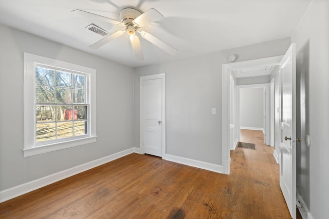 spare room featuring hardwood / wood-style flooring and ceiling fan