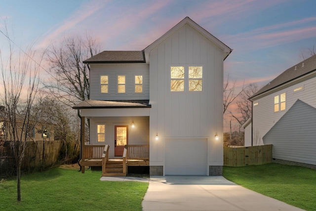 exterior space featuring a porch, a garage, and a lawn