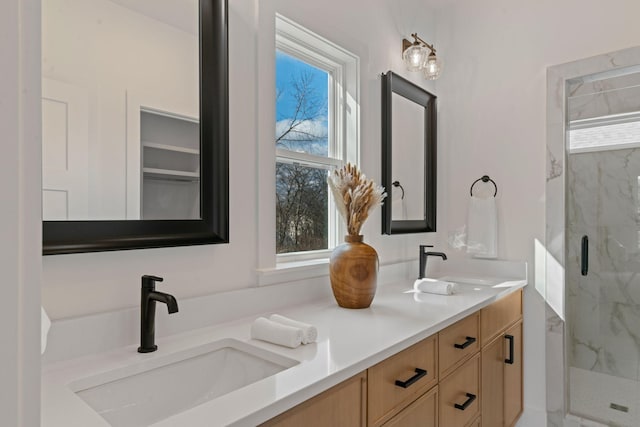 bathroom featuring an enclosed shower and vanity