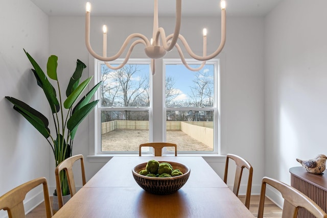 dining room featuring hardwood / wood-style floors and a chandelier