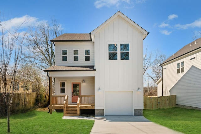 view of front of property featuring a garage, a front yard, and covered porch