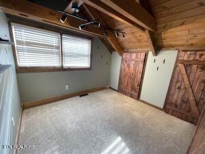 bonus room with vaulted ceiling and carpet floors